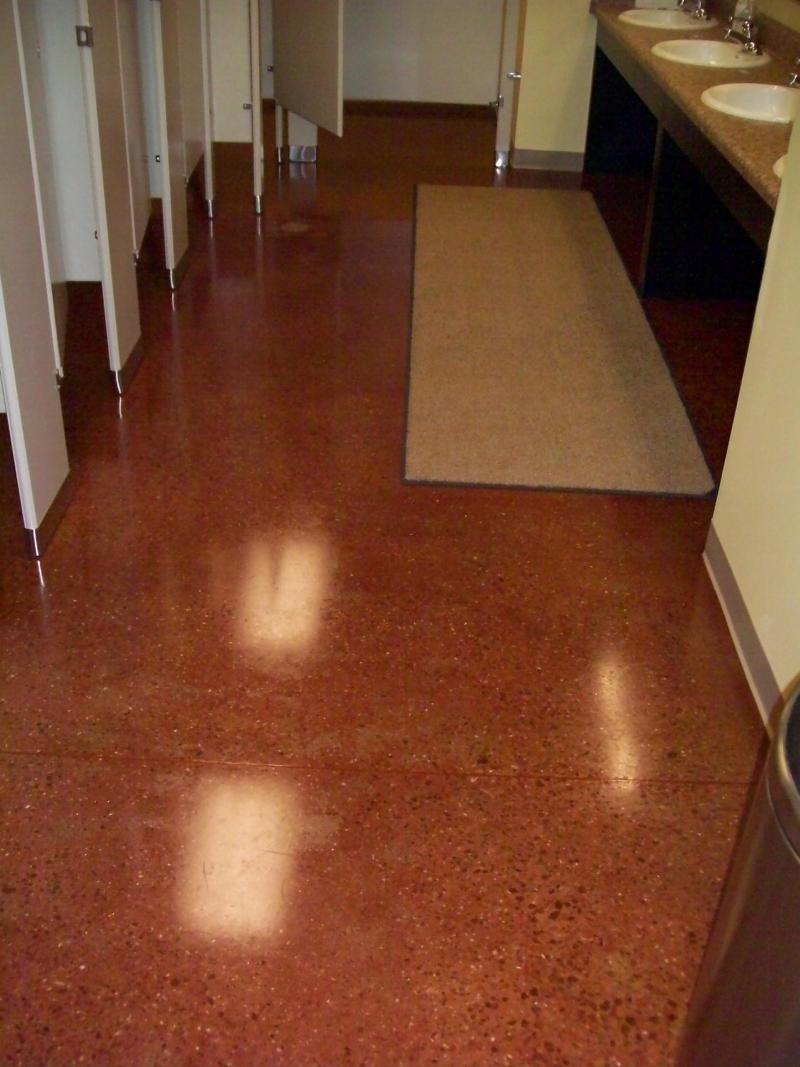 Ground concrete with exposed aggregate, saddle brown color and urethane sealer